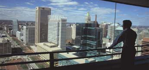 Man looking out window from observation level Photo