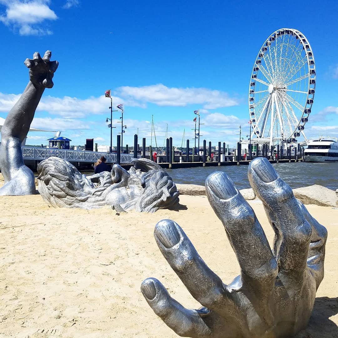 The Awakening statue of a giant emerging from sand