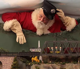 Santa overlooking the Holiday Train Garden at the Fire Museum of Maryland