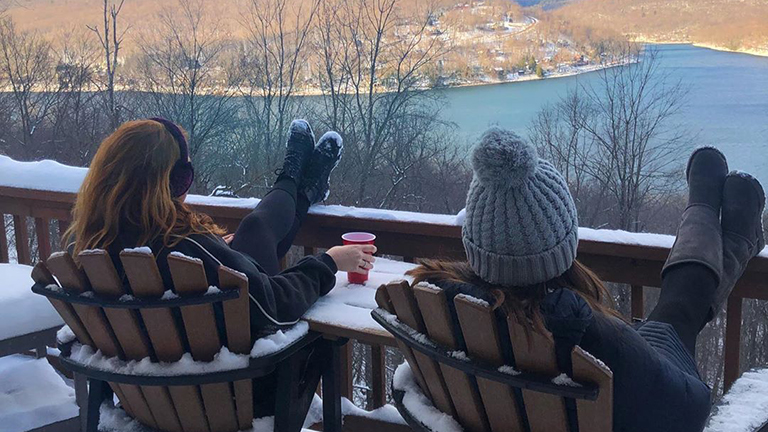 Two people relaxing and enjoying the wintery mountain view in Western Maryland.