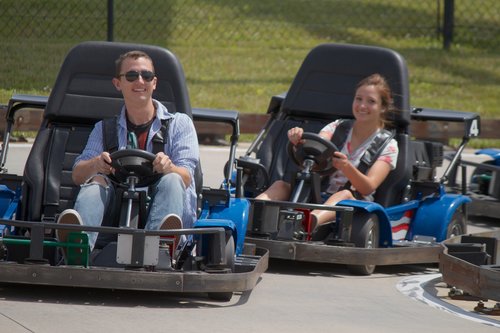 Boy and girl riding in go karts