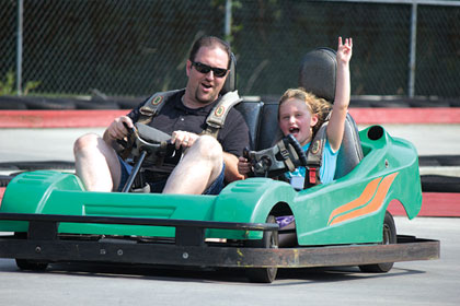 Father and daughter riding in a GoKart