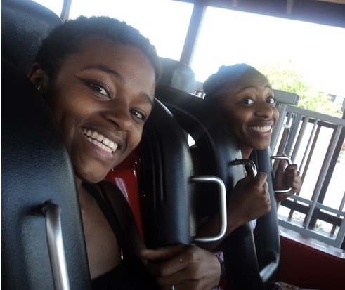 Two people riding a Roller Coaster