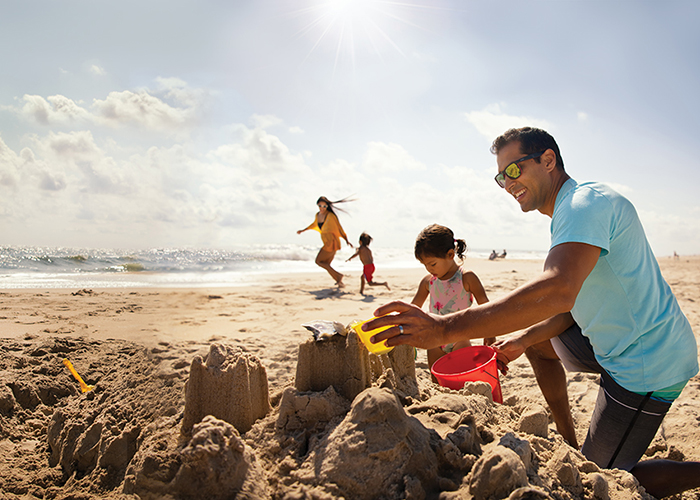 Family building sandcastle 