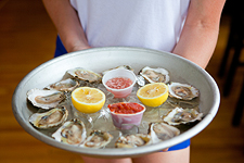 Oysters being served on a platter by Sophie Mac