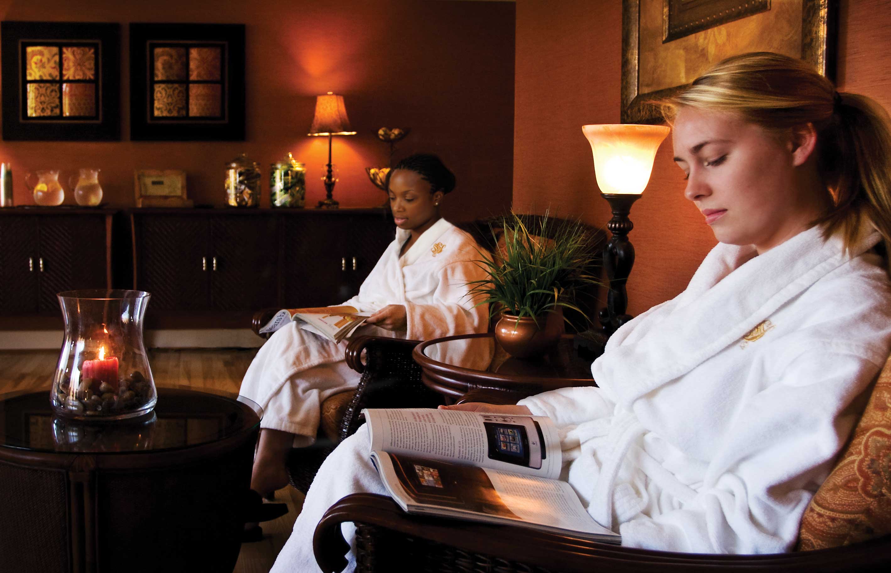 Two women wear white robes at Turf Valley Spa