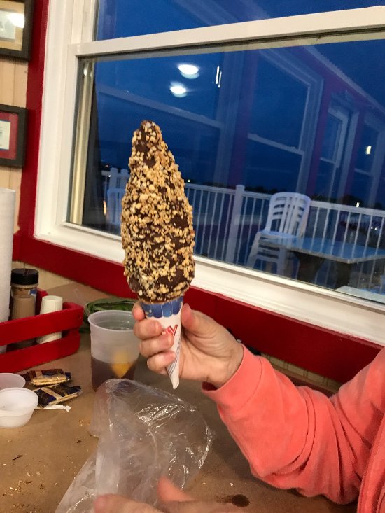 A customer holds up the famous Nutty Buddy Dessert Cone