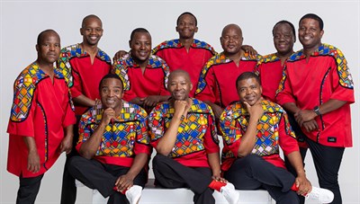 Ladysmith Black Mambazo wearing colorful red tunics. Photo
