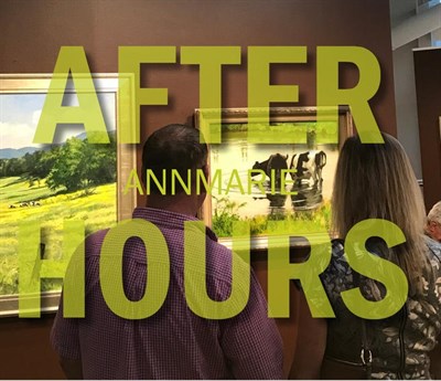 an image with two people looking thoughtfully at a piece of art.  Photo