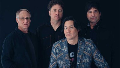 Members of Big Head Todd and The Monsters on a black background. Photo