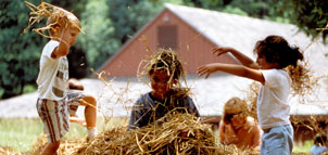 Children in playing in hay Photo