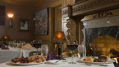 Romantic dinner for two by the fireplace. Photo