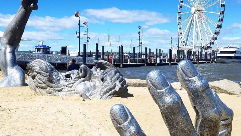 The Awakening statue of a giant emerging from sand