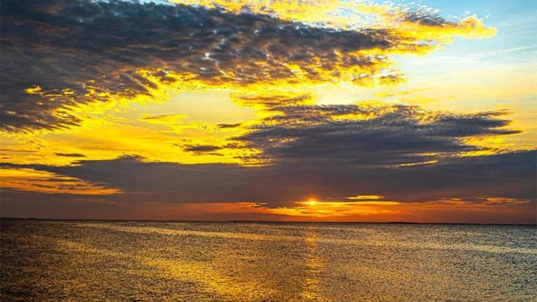 Sunrise over the water at North Beach