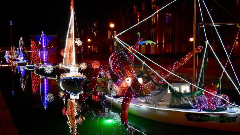 Boats decorated with holiday lights in creek 
