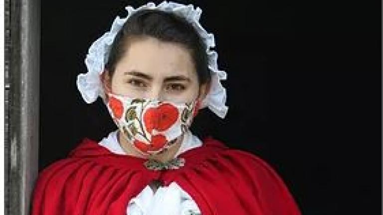 Masked colonial woman