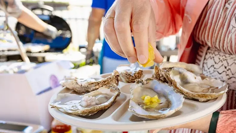 A person holding a tray of shuked oyster at the U.S Oyster Festival in Leaonardtown, Maryland in October