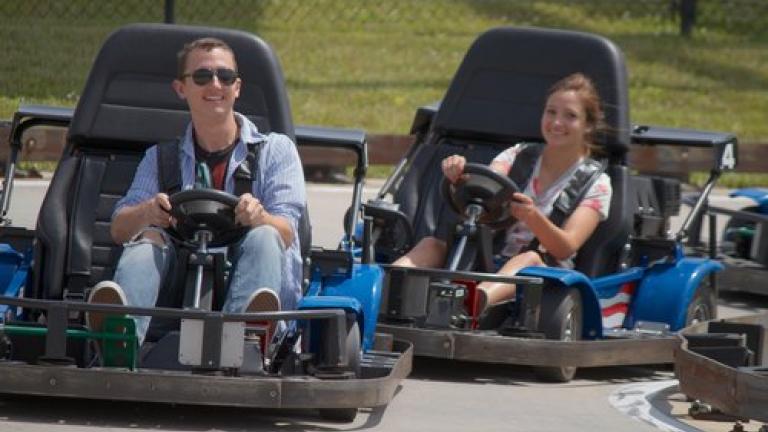 Boy and girl riding in go karts