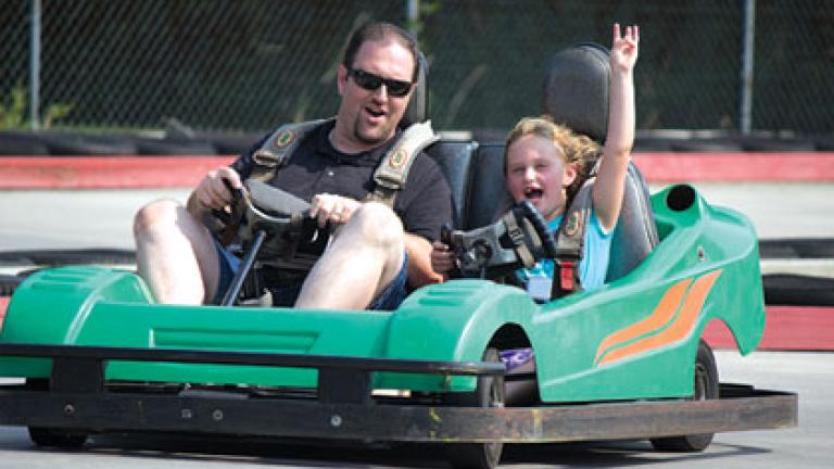 Father and daughter riding in a GoKart