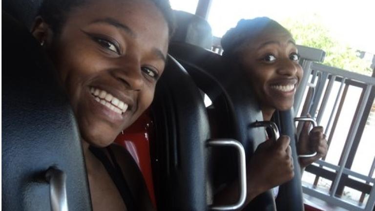 Two people riding a Roller Coaster