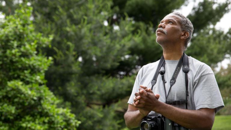 man with binoculars and camera