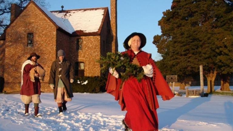 woman walking through snow in red cape