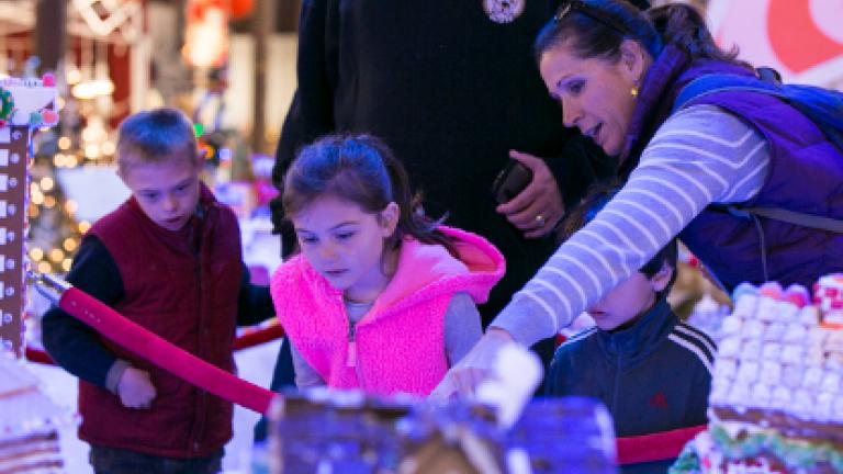 Family looking at gingerbread houses