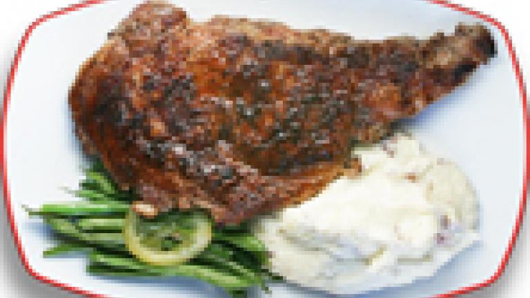 Ribeye steak with mashed potatoes and green beans
