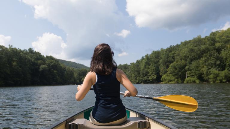 A woman rowing in a lovely lake