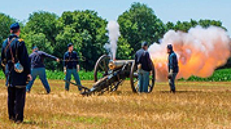 Union soldier reenactors firing a canon