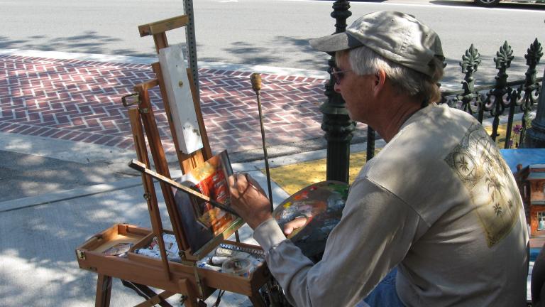 Man painting at a plein air festival