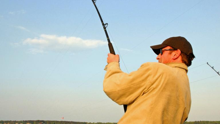 man fishing on boat