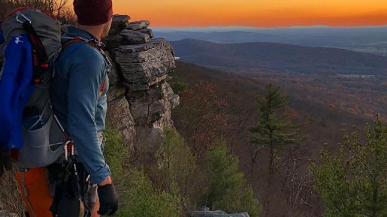 hiker at a hilltop