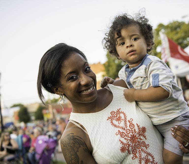 Mom holding child at Festival