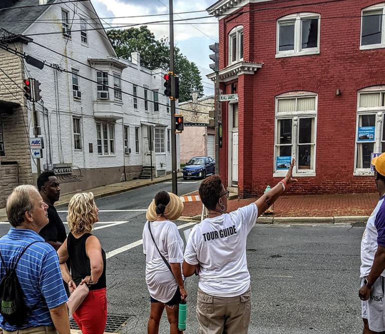Dee Jenkins pointing to 100 W. All Saints Street in Frederick.