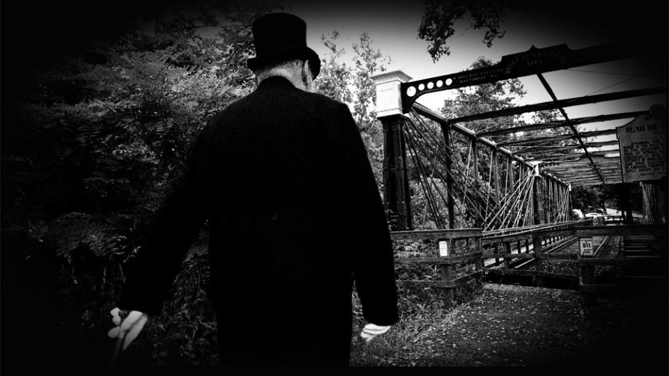 man walking along railroad tracks