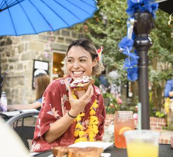Young woman eating a open-faced sandwich