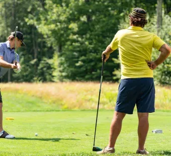 Three men golfing.