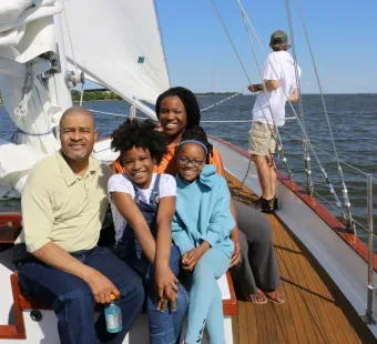 family riding on schooner woodwind