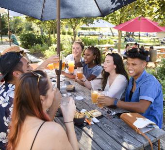 Friends enjoying drinks and food together.