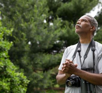 man with binoculars and camera