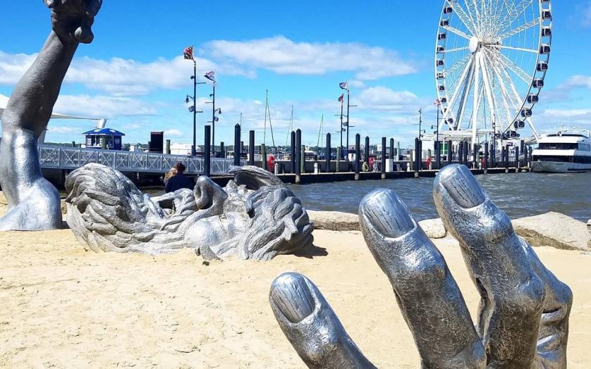 The Awakening statue of a giant emerging from sand