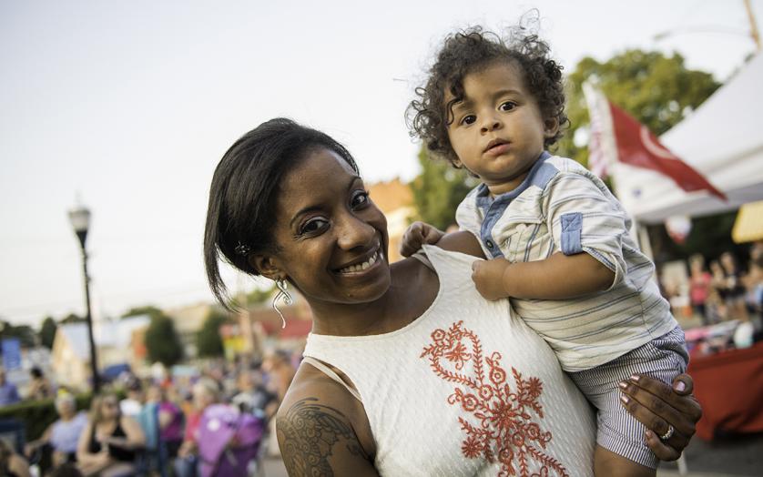 Mom holding child at Festival