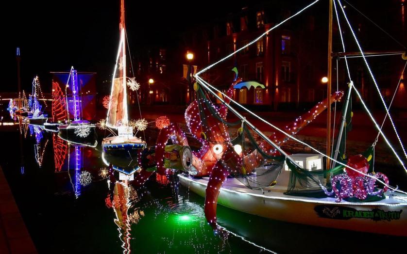 Boats decorated with holiday lights in creek