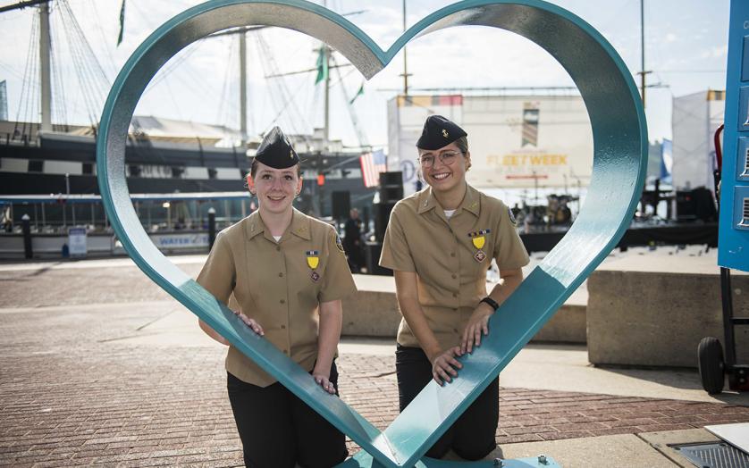 Two U.S Navy Women pictured inside the Baltimore Inner Harbor's Heart Art.