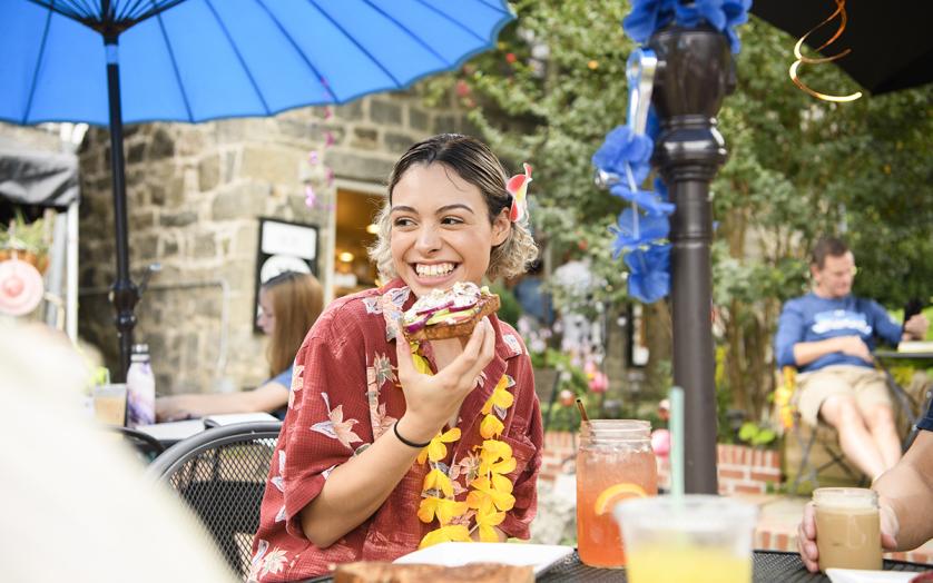 Young woman eating a open-faced sandwich