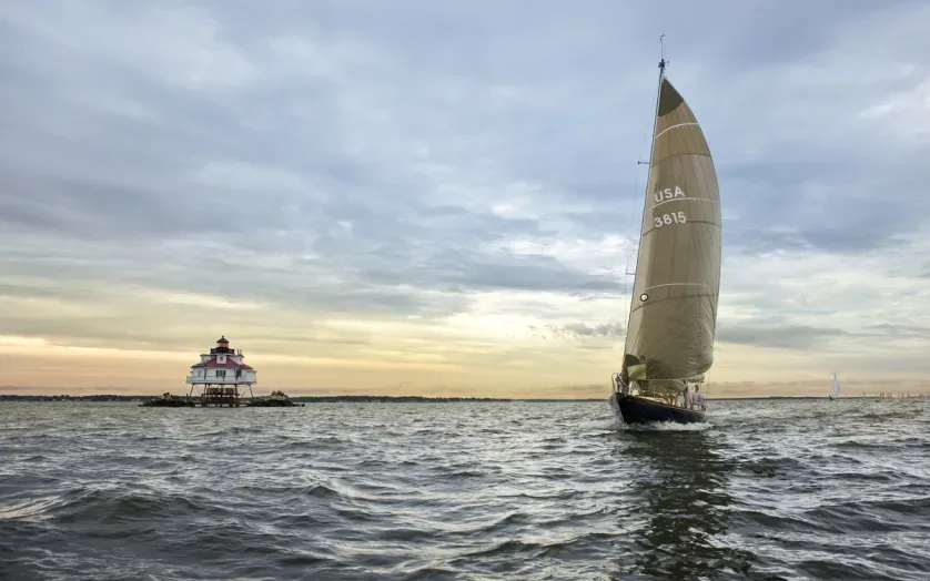 Sailboat racing past Thomas Point Lighthouse