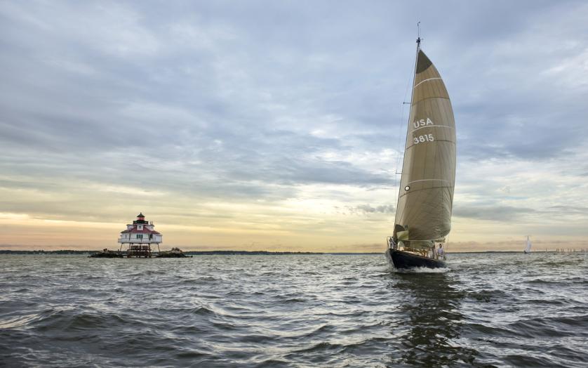 Sailboat racing past Thomas Point Lighthouse