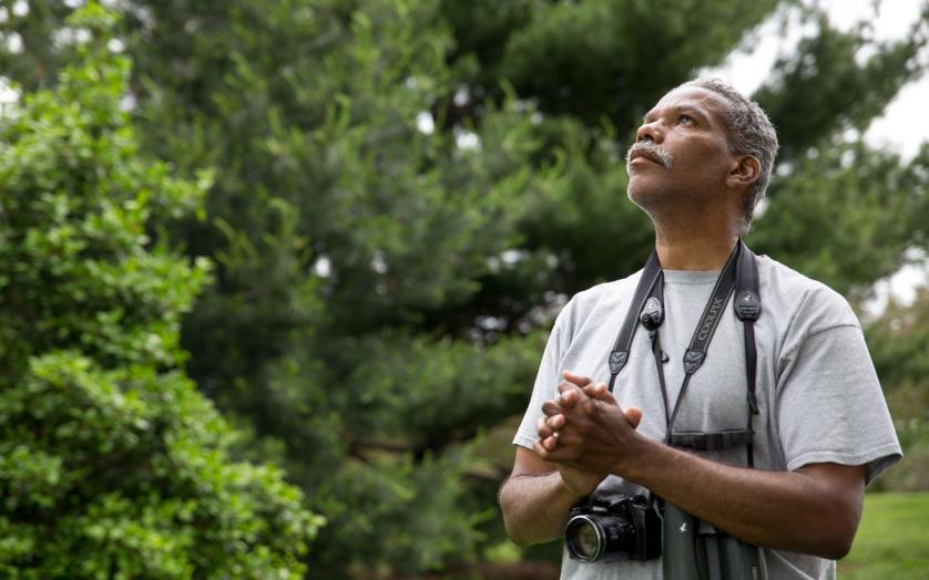 man with binoculars and camera