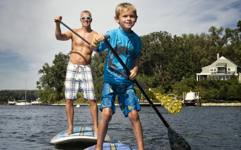 Adult and child paddleboarding